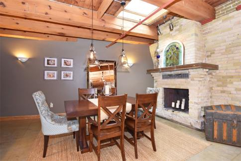 Dining room with fireplace &amp; skylight